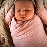 newborn, baby, sleeping, swaddled, pink_wrap, headband, flower, basket, blanket, cozy, soft_texture, infant, peaceful, cute, portrait, closeup, sleep, child, adorable, resting