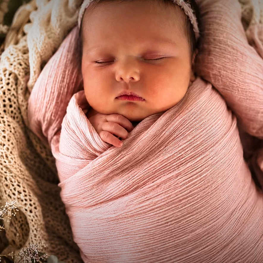 Kora is registered to the contest to win money with this photo: newborn, baby, sleeping, swaddled, pink_wrap, headband, flower, basket, blanket, cozy, soft_texture, infant, peaceful, cute, portrait, closeup, sleep, child, adorable, resting