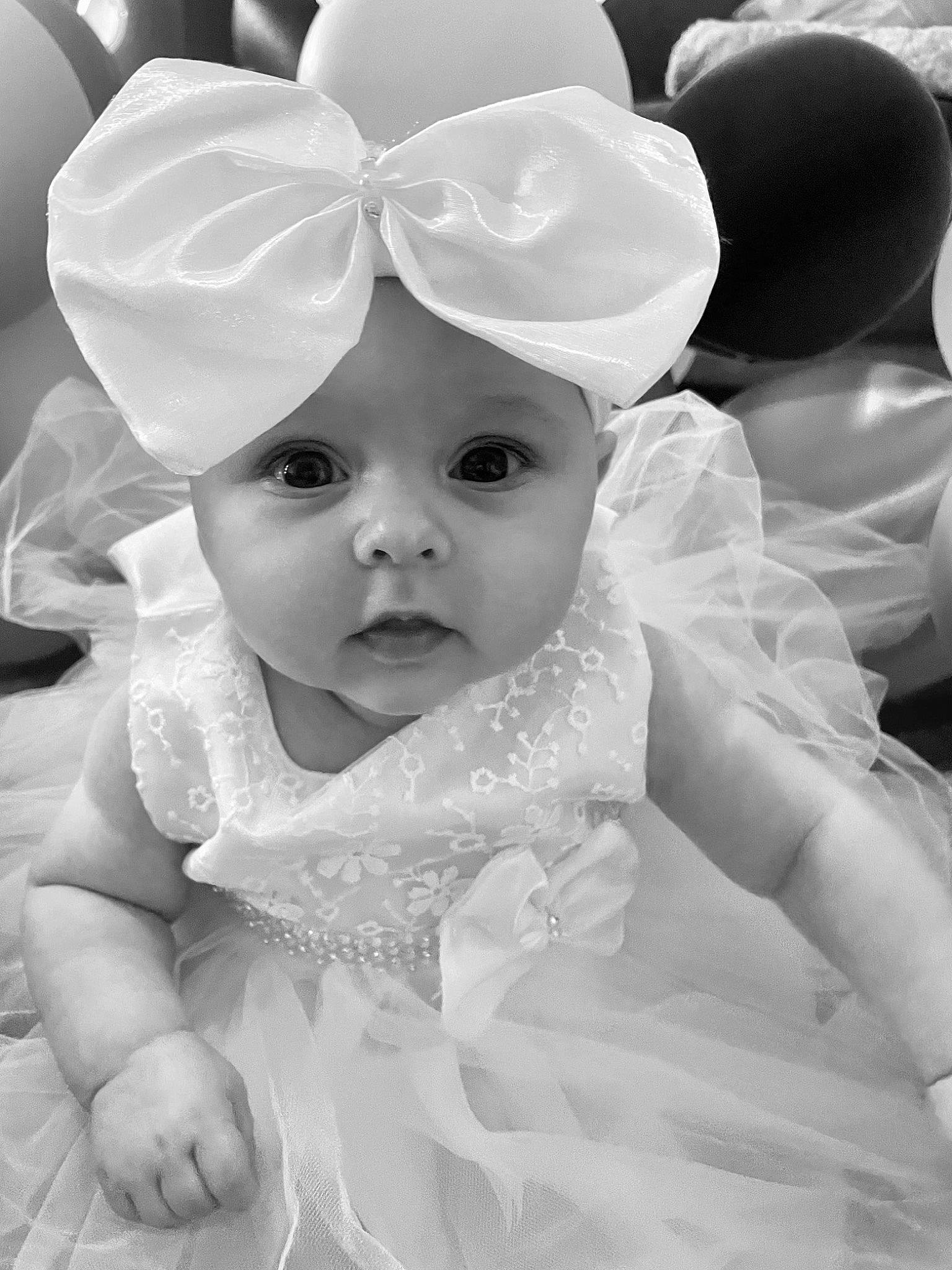 Giarnie joined the competition — help win amazing prizes! baby, baby_toddler_clothing, bridal_accessory, cap, child, dress, eye, flash_photography, fun, gesture, happy, headpiece, headwear, interaction, monochrome, people, person, petal, pink, textile