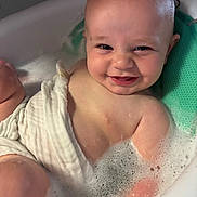 Jace joined the competition — help win amazing prizes! baby, bath, bubbles, smile, water, skin, face, child, infant, happy, foam, white_cloth, bathtub, cute, person, relaxation, sitting, playful, indoors, head