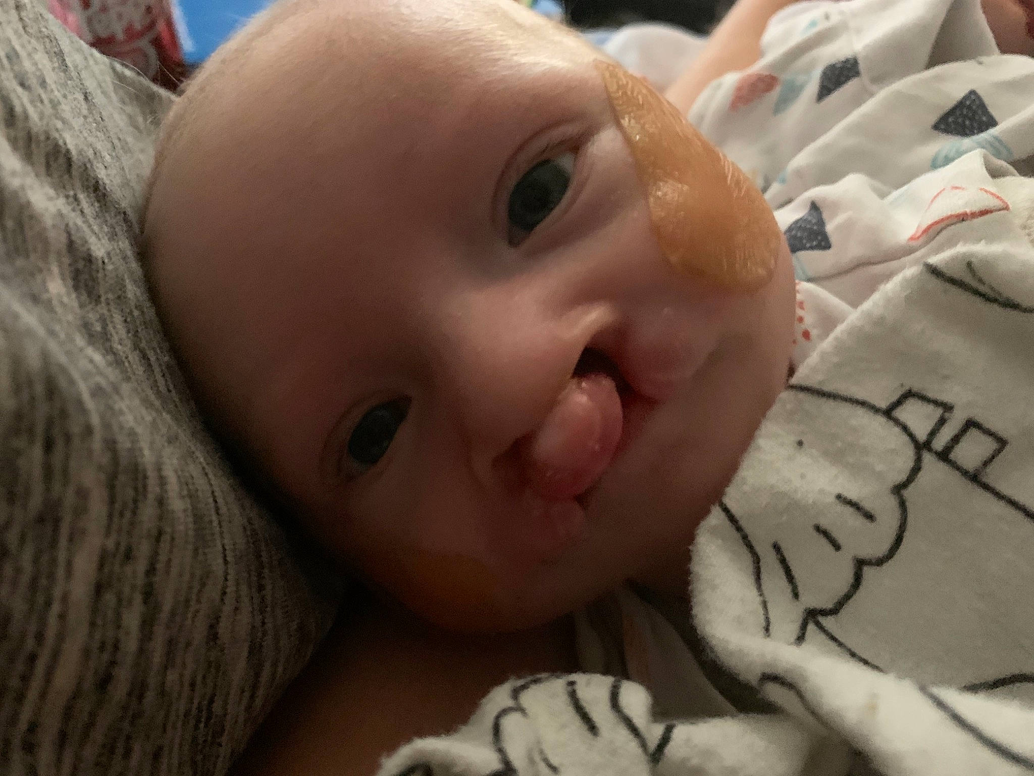 Keelyn is registered to the contest to win money with this photo: baby, baby_toddler_clothing, cheek, child, facial_expression, linens, lip, person, skin, tongue