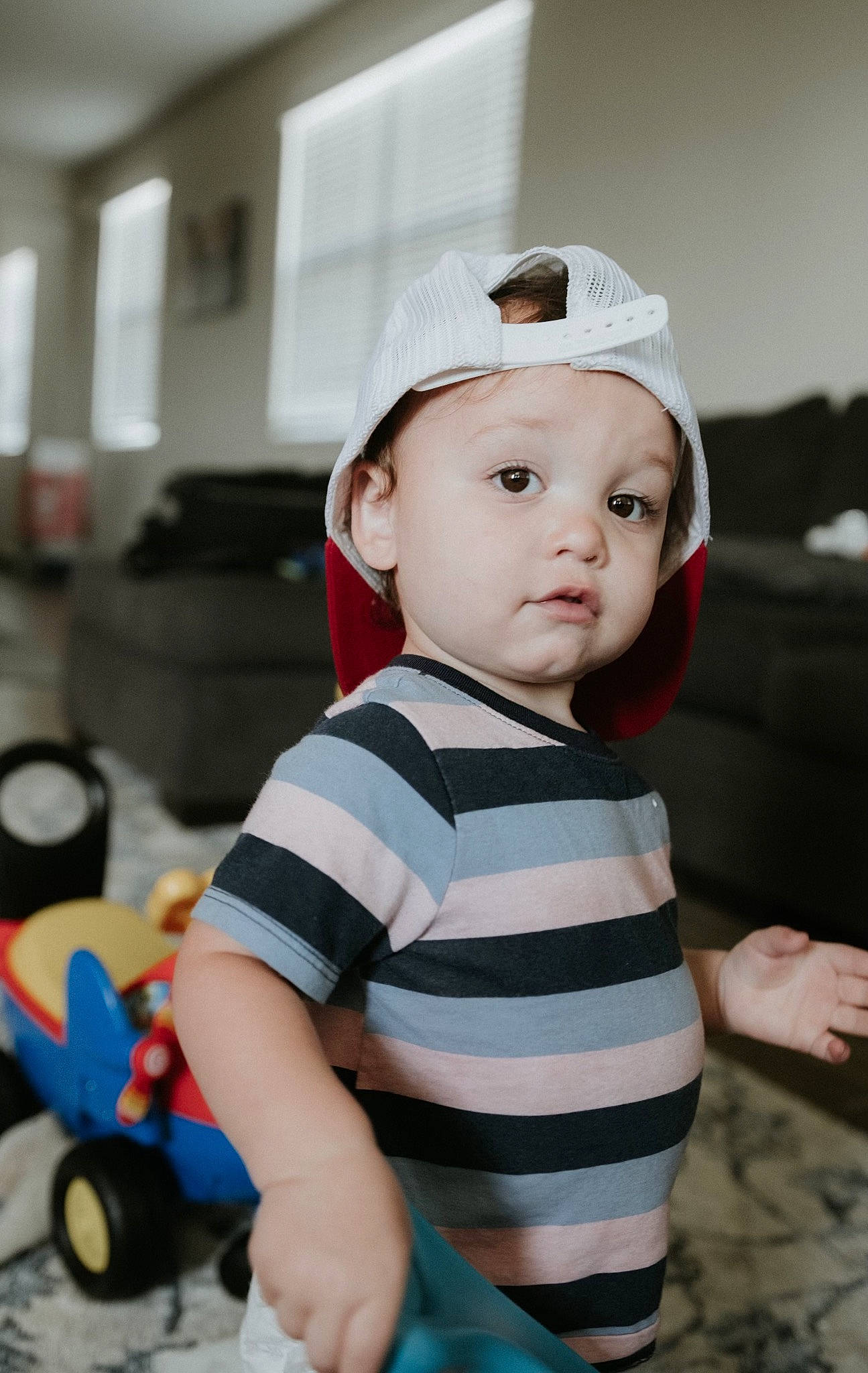 Gideon is registered to the contest to win money with this photo: baby, baby_playing_with_toys, baby_toddler_clothing, cap, cheek, child, flash_photography, flooring, fun, happy, hat, headwear, machine, person, rolling, sitting, sleeve, t_shirt, toddler, toy
