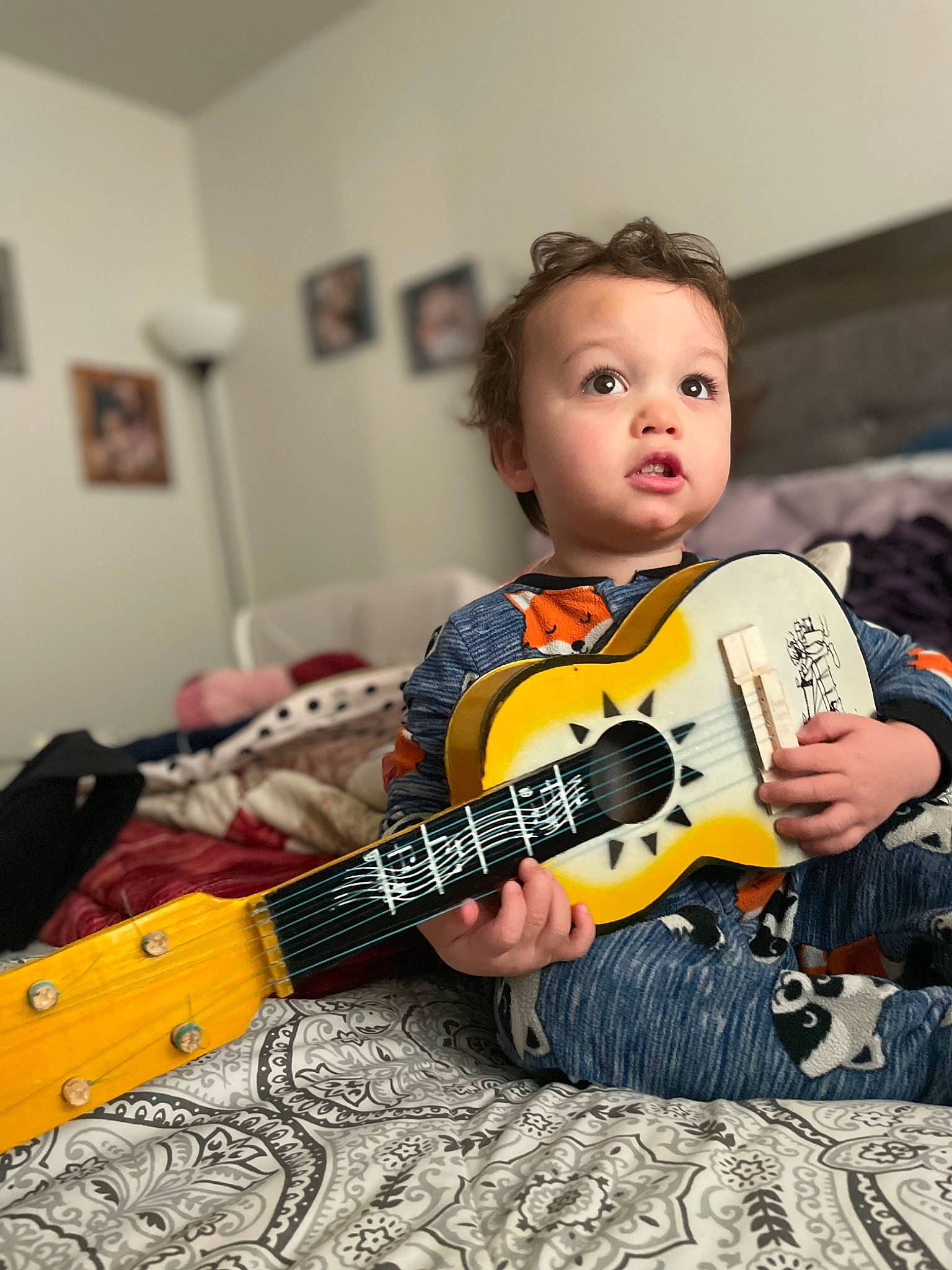 Gideon is registered to the contest to win money with this photo: acoustic_guitar, child, electric_guitar, guitar, guitar_accessory, guitarist, happy, jazz_guitarist, music, musical_instrument, musical_instrument_accessory, musician, person, picture_frame, plucked_string_instruments, string_instrument, string_instrument_accessory, surprise, t_shirt, toddler