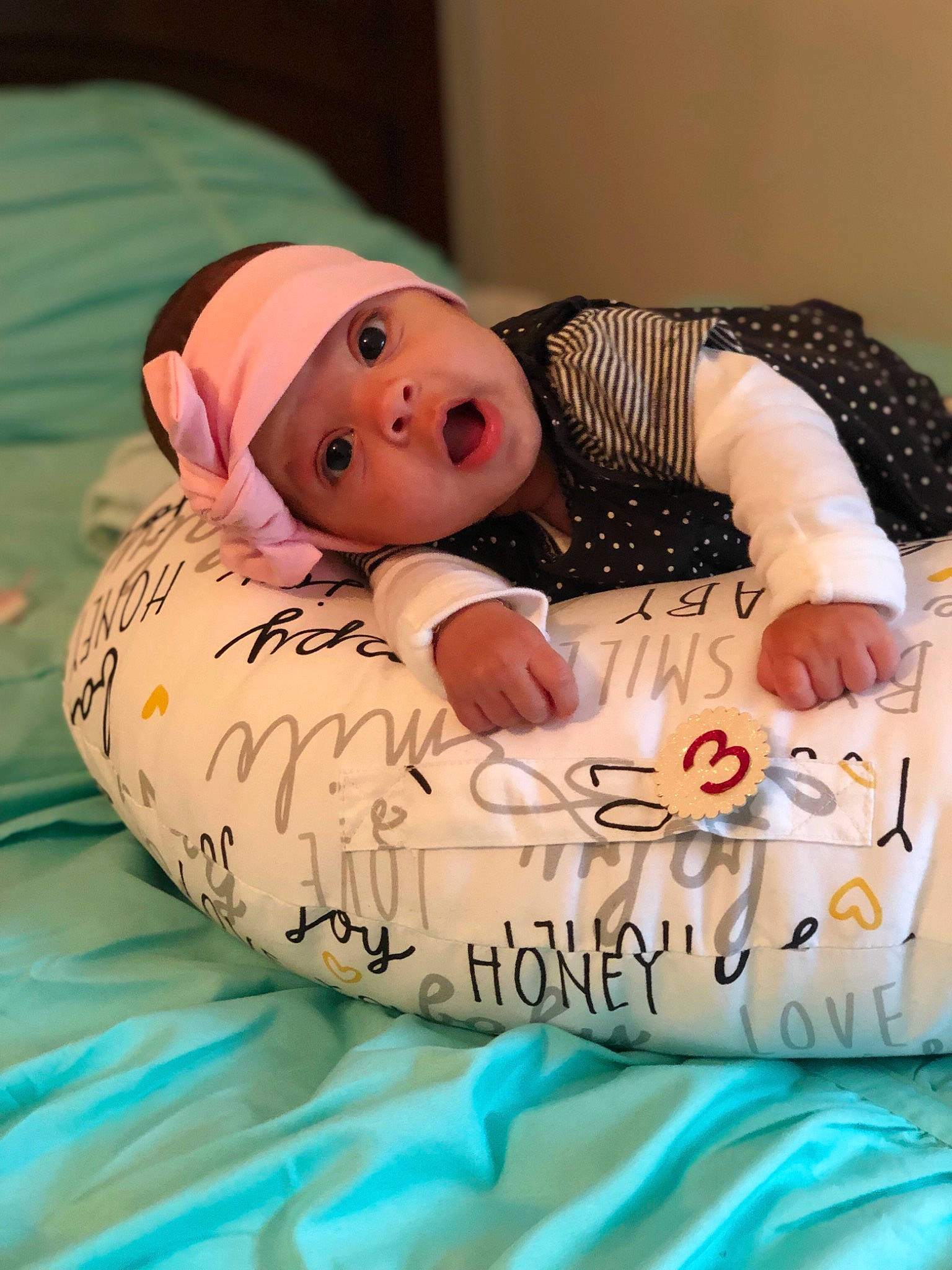 Amayah is registered to the contest to win money with this photo: baby, baby_products, bedtime, birth, cheek, child, furniture, headwear, person, product, surprise, textile, toddler
