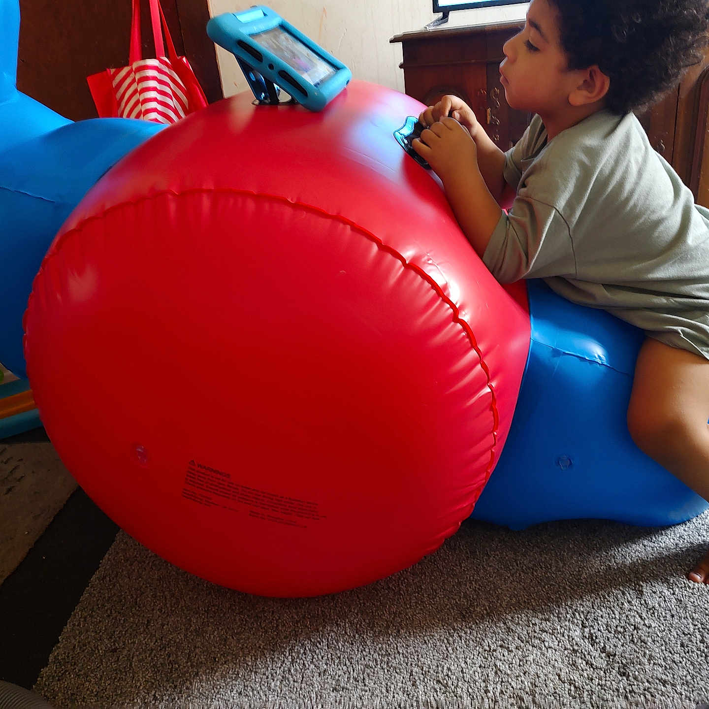 Elijiah Aarron is registered to the contest to win money with this photo: accessories, bag, balloon, bodypart, boy, child, electronics, face, finger, hand, handbag, head, indoors, inflatable, male, mobilephone, person, phone, playarea, sphere