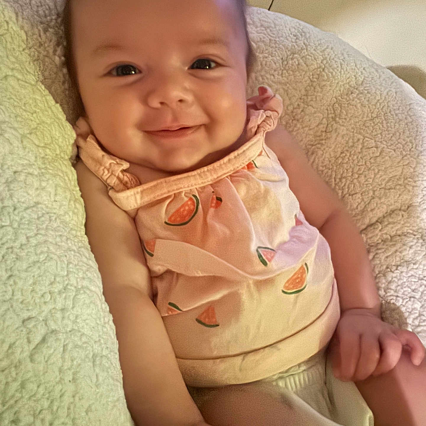 Madilynn joined the competition — help win amazing prizes! baby, smile, infant, cushion, soft, clothing, watermelon_print, cute, happy, skin, face, child, indoors, texture, comfort, closeup, young, person, sitting, relaxed