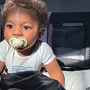 Dior joined the competition — help win amazing prizes! toddler, child, pacifier, curly_hair, white_shirt, bed, blanket, indoor, playpen, furniture, light, shadow, face, eyes, skin, crawling, infant, young_child, cute, portrait