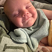 Easton is registered to the contest to win money with this photo: baby, smiling, pacifier, towel, sleeping, face, skin, child, infant, closeup, resting, comfort, soft, cute, portrait, peaceful, human, indoors, blanket, cozy