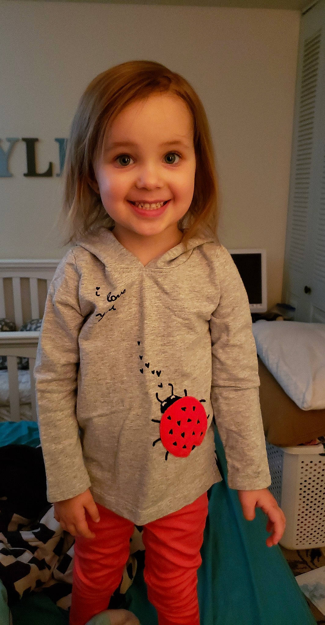 Jocelyn is registered to the contest to win money with this photo: baby_toddler_clothing, cheek, child, clothing, hoodie, joy, outerwear, pattern, person, play, sleeve, smile, standing, sweater, t_shirt, textile, toddler, top