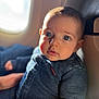 baby, child, denim, jacket, airplane, window, seat, face, blue_eyes, curious, light, portrait, infant, clothing, cute, indoor, person, sitting, closeup, young