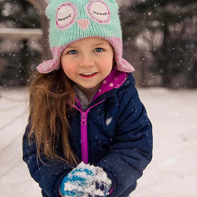 Mira is registered to the contest to win money with this photo: beanie, bonnet, cap, child, clothing, cool, crochet, freezing, fun, headgear, joy, knit_cap, outerwear, person, pink, play, playing_in_the_snow, purple, smile, snow