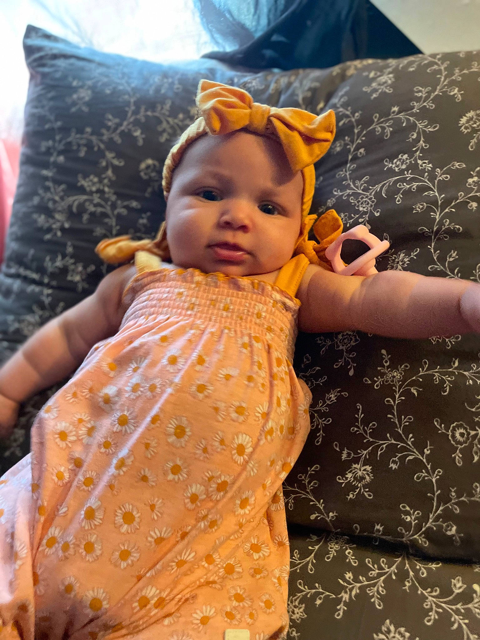 Azalea is registered to the contest to win money with this photo: baby, baby_toddler_clothing, bedding, child, comfort, doll, event, face, fashion_design, happy, linens, pattern, peach, person, pillow, pink, skin, sleeve, textile, toddler