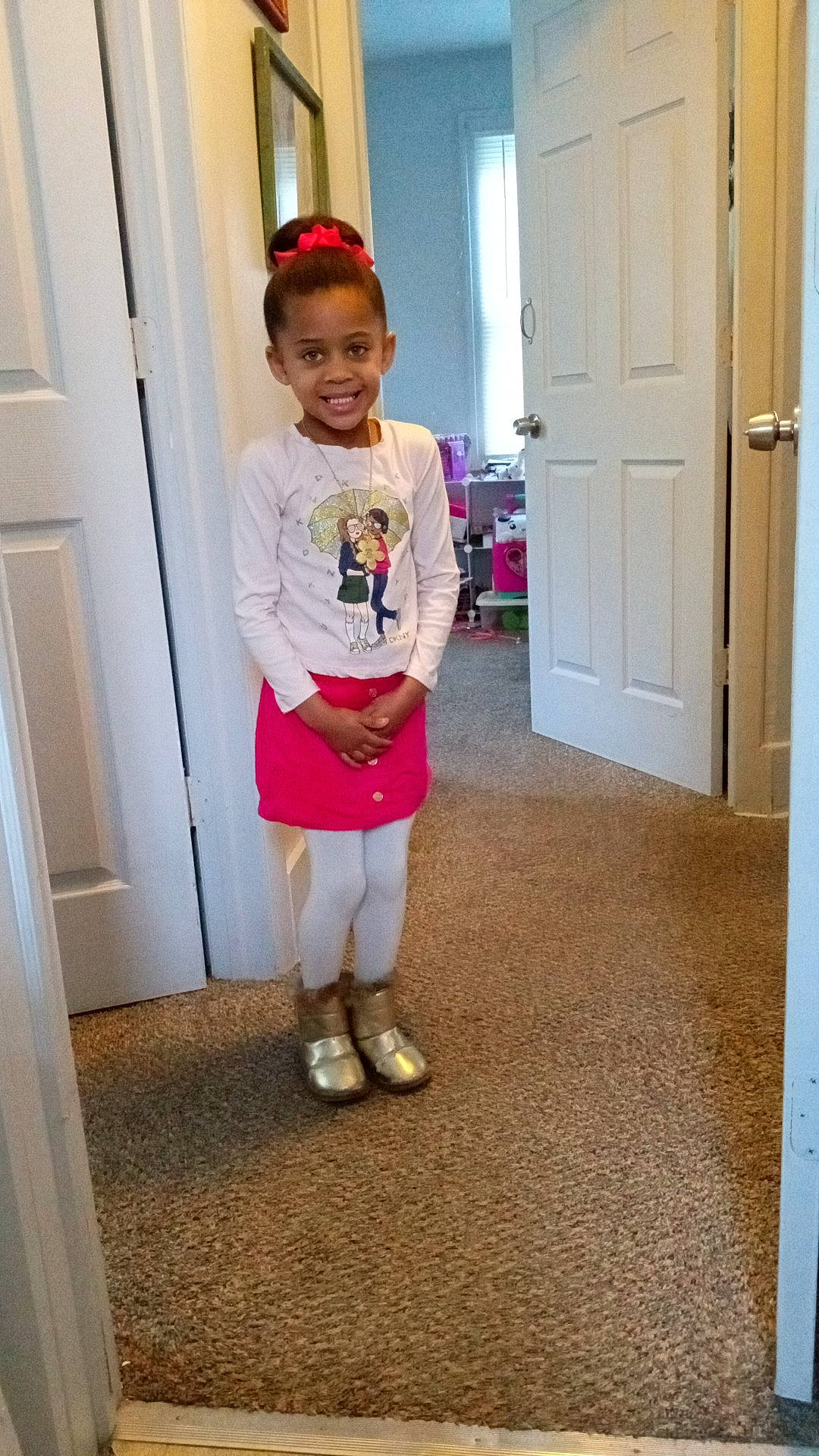 Jianna is registered to the contest to win money with this photo: baby_toddler_clothing, child, door, door_handle, floor, flooring, happy, hardwood, home_door, human_leg, joint, joy, knee, magenta, person, shoe, sleeve, smile, t_shirt, thigh