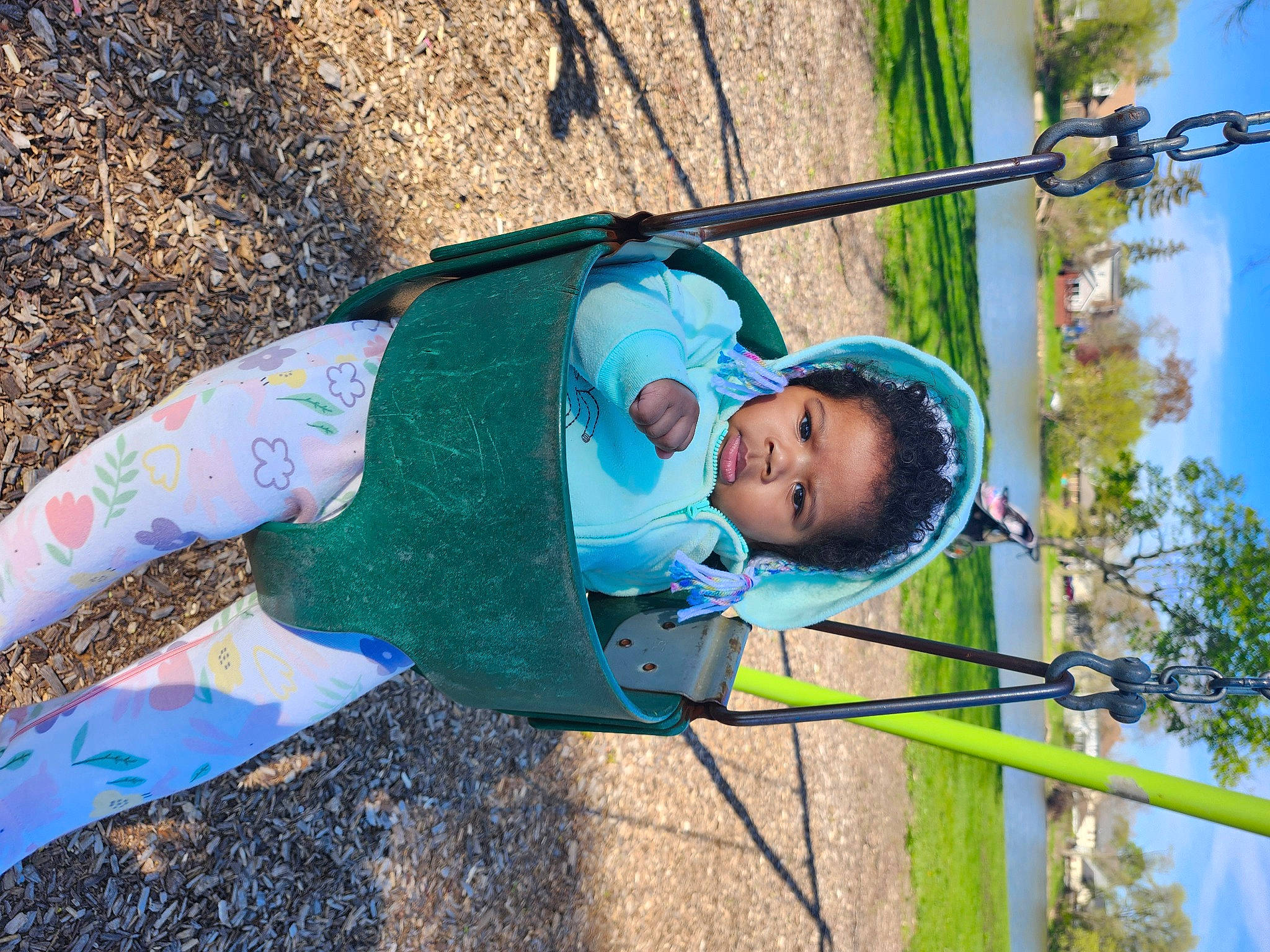 Janelle is registered to the contest to win money with this photo: azure, baby_toddler_clothing, child, electric_blue, fun, grass, happy, leaf, leisure, nature, outdoor_play_equipment, people_in_nature, person, plant, playground, recreation, sky, smile, toddler, tree