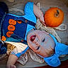 baby, child, blue_bow, denim_overalls, pumpkin, orange, smiling, happy, infant, fall, autumn, cute, face, headband, clothing, person, portrait, texture, background, laying_down