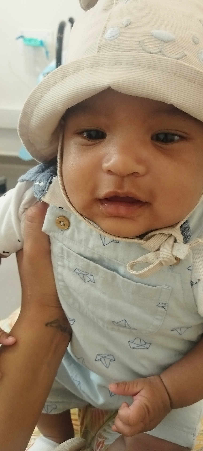Josh participe au concours pour gagner de l'argent avec cette photo : baby, child, hat, overalls, hand, tattoo, cute, face, infant, clothing, paper_boat_pattern, closeup, expression, skin, person, indoor, holding, adorable, portrait, young