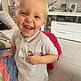 blond_hair, cabinet, child, clothing, couch, floor, furniture, happy, home, indoor, kid, living_room, person, photograph, polo_shirt, portrait, smiling, television, toddler, toy