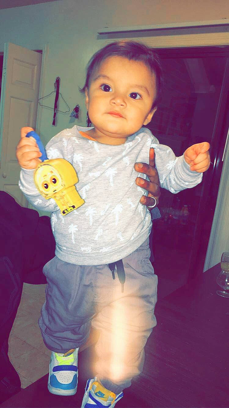 Gael is registered to the contest to win money with this photo: arm, baby, cheek, child, eye, person, play, skin, smile, standing, thumb, toddler