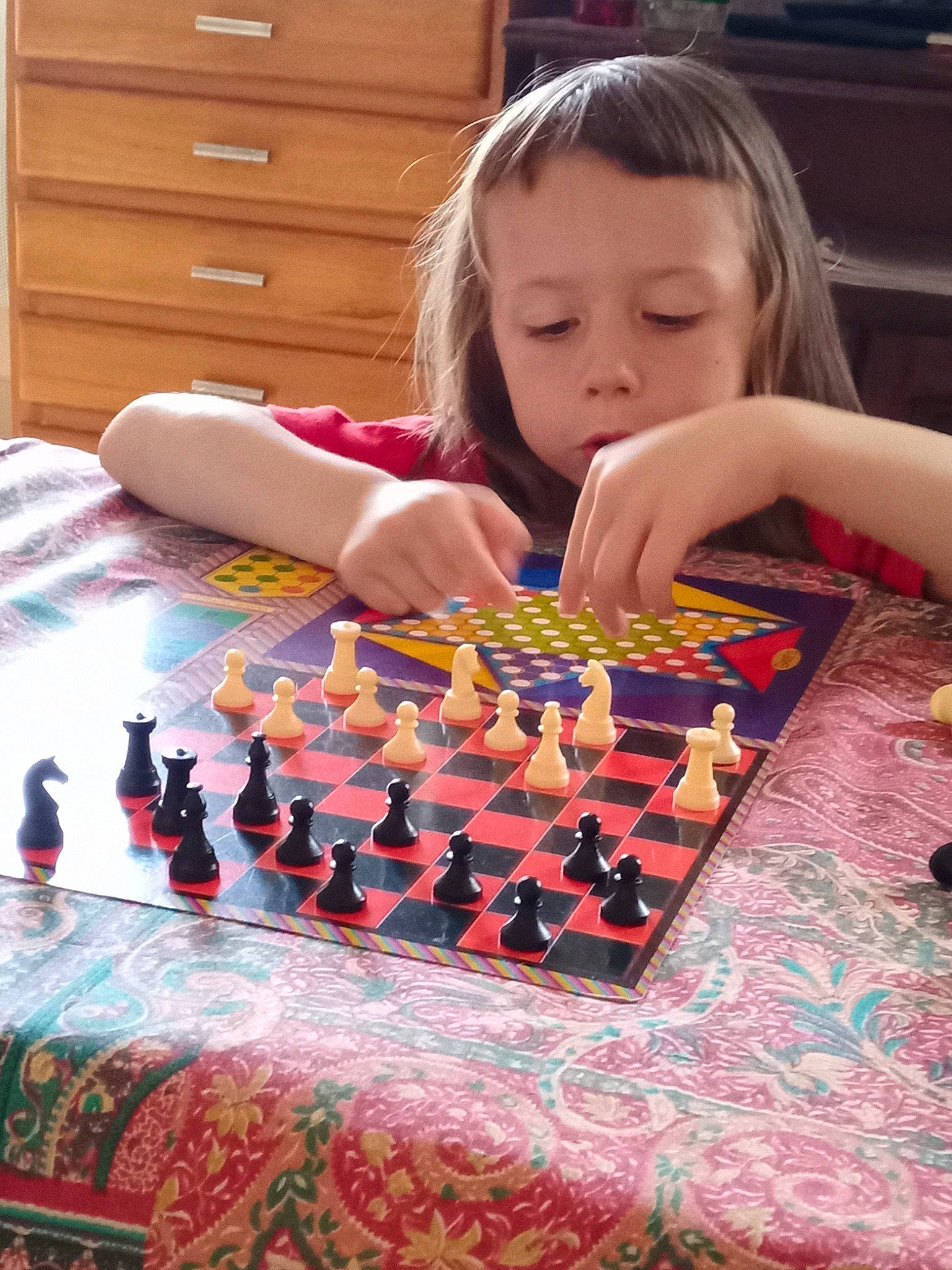 Tery participe au concours pour gagner de l'argent avec cette photo : cabinetry, chest_of_drawers, drawer, dresser, floor, flooring, fun, games, indoor_games_and_sports, leisure, pattern, person, play, recreation, room, textile, toddler, toy, varnish, wood