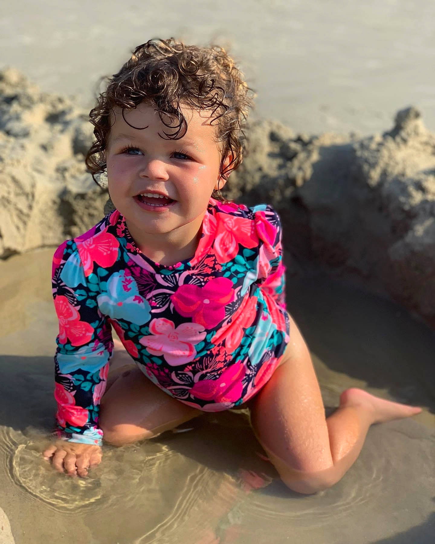 Sophia is registered to the contest to win money with this photo: beach, body_of_water, child, eye, face, flash_photography, fun, happy, head, landscape, leisure, people_in_nature, people_on_beach, person, recreation, sand, skin, sleeve, t_shirt, toddler