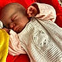 Manon a rejoint le concours — aidez-le/la à gagner de superbes lots ! baby, sleeping, infant, face, hand, clothing, blanket, red_background, cute, soft_texture, cozy, resting, peaceful, portrait, child, newborn, fabric, closeup, indoor, cute_embroidery
