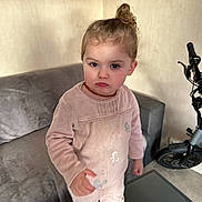 Kélya Lenfant participe au concours pour gagner de l'argent avec cette photo : butterfly_pattern, casual, child, couch, electric_scooter, floor, furniture, glass_table, home, indoor, necklace, person, pink_outfit, serious_expression, short_hair, standing, toddler, toy_vehicle, wall, young_child