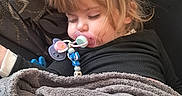 Kélya Lenfant a rejoint le concours — aidez-le/la à gagner de superbes lots ! blanket, child, clothing, comfort, couch, cozy, decor, face, furniture, hair, home, indoor, nap, pacifier, peaceful, relaxation, sleeping, toddler, toy, young_child
