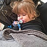 blanket, child, clothing, comfort, couch, cozy, decor, face, furniture, hair, home, indoor, nap, pacifier, peaceful, relaxation, sleeping, toddler, toy, young_child
