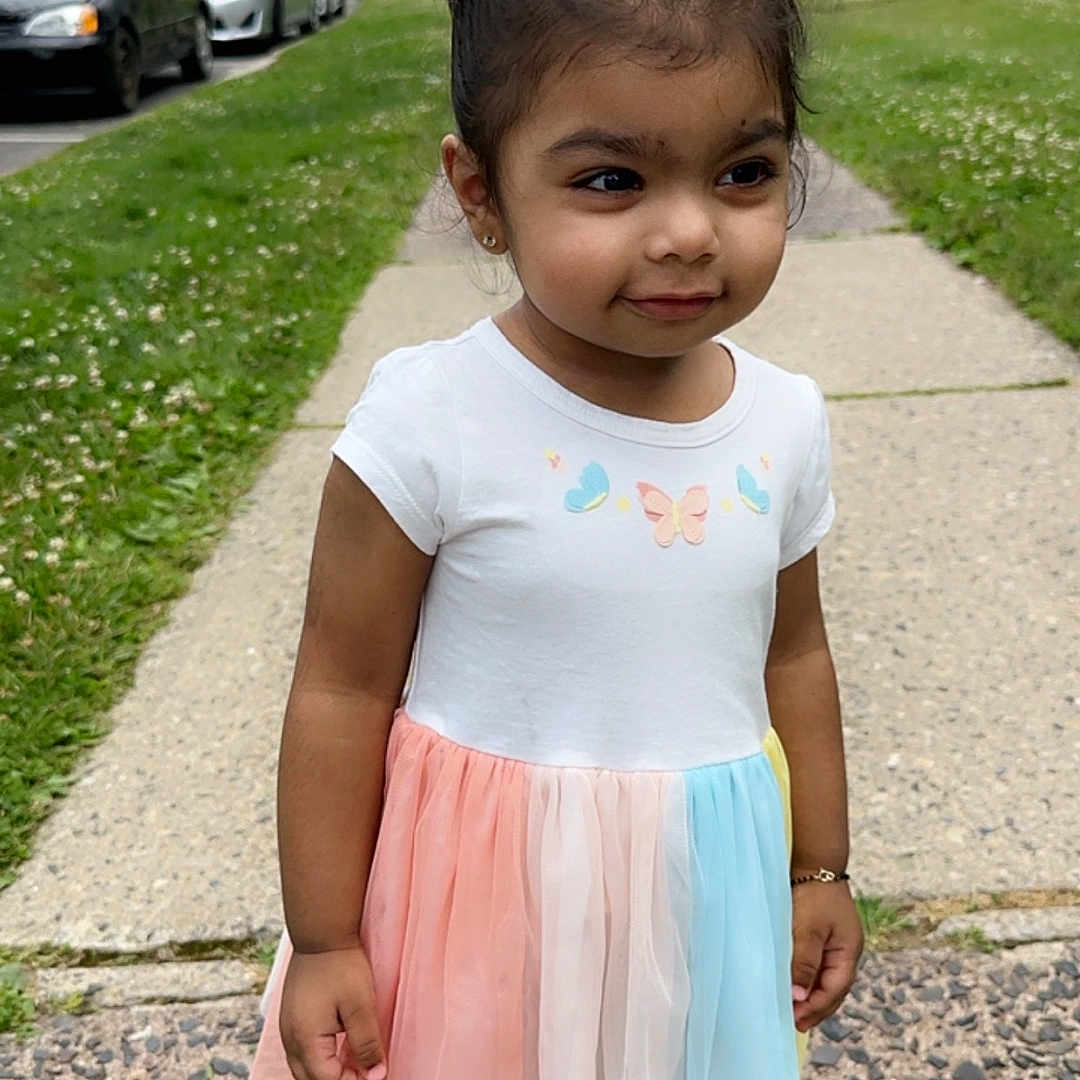 Serenity is registered to the contest to win money with this photo: child, city, clothing, dress, face, female, footwear, girl, grass, head, path, person, photography, plant, portrait, road, sidewalk, skirt, street, urban