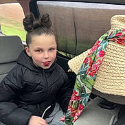 Ennélya participe au concours pour gagner de l'argent avec cette photo : child, car_interior, black_jacket, playful, tongue_out, scarf, floral, hat, seat, window, seatbelt, person, young, casual, fun, hair_bun, winter_clothing, indoor, transport, smiling