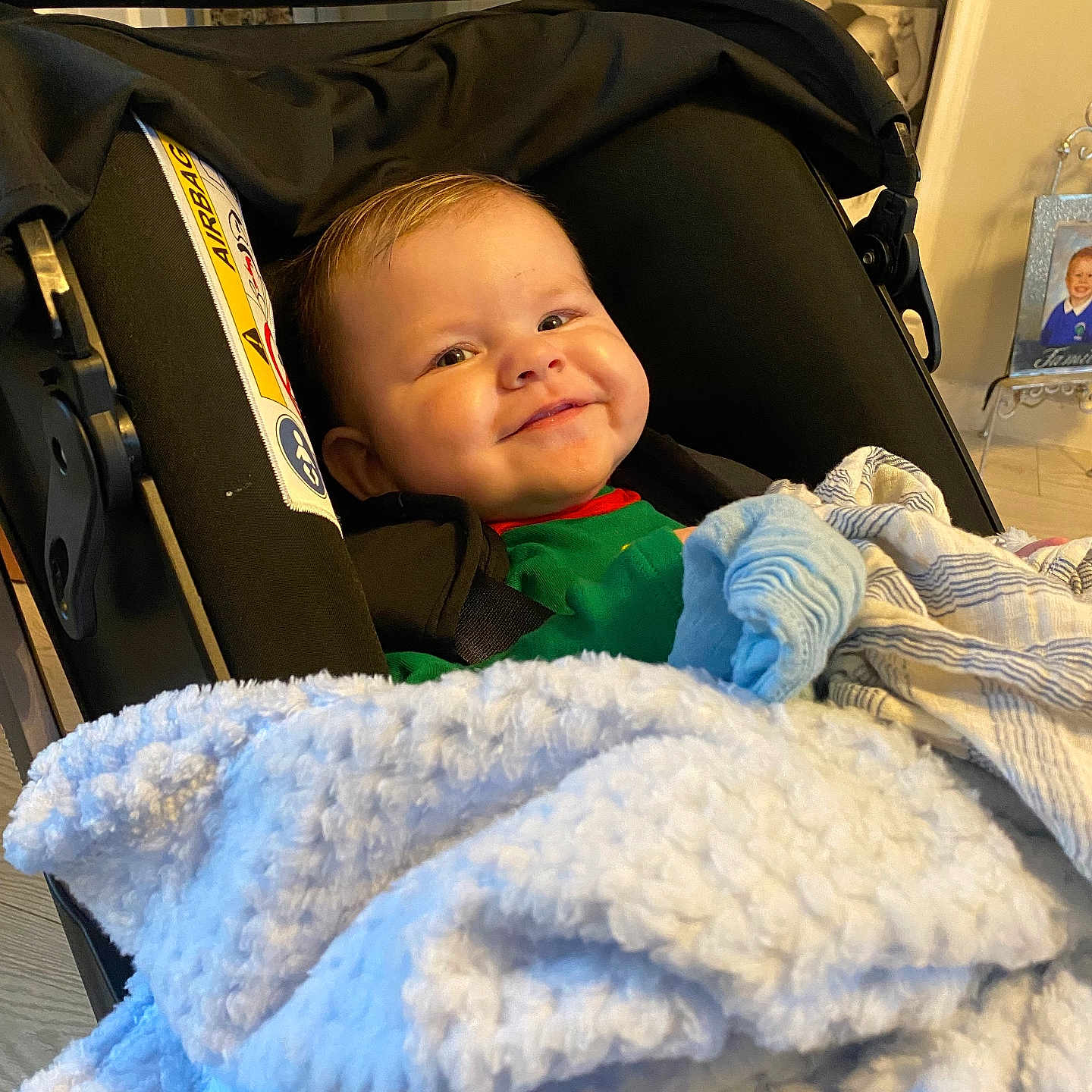 Louie is registered to the contest to win money with this photo: baby, blanket, child, clothing, comfort, cozy, cute, fabric, face, happy, home, indoor, infant, person, photography, portrait, seat, smile, stroller, young