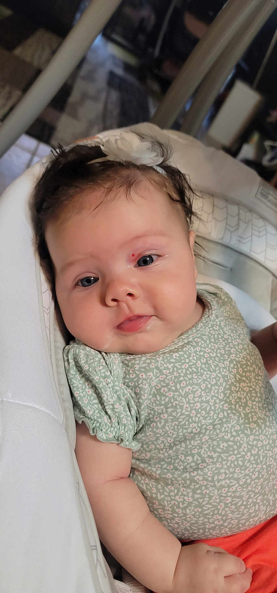 Analina joined the competition — help win amazing prizes! baby, infant, child, face, headband, flower, drool, red_mark, green_top, orange_pants, indoor, closeup, cute, relaxed, skin, person, portrait, sitting, young, soft_lighting