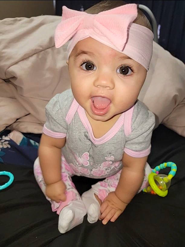 Davina joined the competition — help win amazing prizes! baby, baby_products, baby_toddler_clothing, cap, cheek, child, comfort, finger, fun, happy, headwear, human_body, magenta, mouth, person, pink, sitting, skin, sleeve, surprise