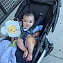 Arely joined the competition — help win amazing prizes! baby, stroller, child, smile, plush_toy, flower, blanket, foot, face, happy, outdoor, person, clothing, seatbelt, head, toy, cute, infant, sitting, sidewalk