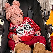 Arely is registered to the contest to win money with this photo: baby, sleeping, stroller, hat, pom_poms, sweater, mickey_mouse, red, white, boots, tan, knit, cozy, winter, child, clothing, cute, peaceful, infant, accessory