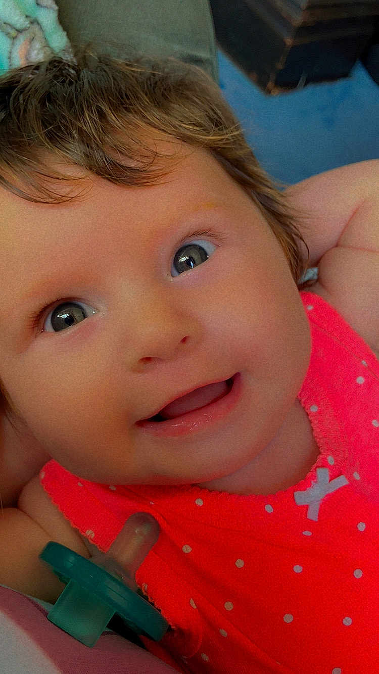 Staylee is registered to the contest to win money with this photo: baby, smiling, close_up, face, child, pacifier, pink_clothing, polka_dot, happy, cute, infant, portrait, young_child, indoors, skin, eyes, hair, expression, toddler, cheerful