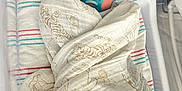 Hudson Bear is registered to the contest to win money with this photo: newborn, baby, pacifier, swaddled, blanket, hospital, bassinet, sleeping, infant, cute, soft, wrapped, child, peaceful, indoors, healthcare, bed, person, closeup, resting