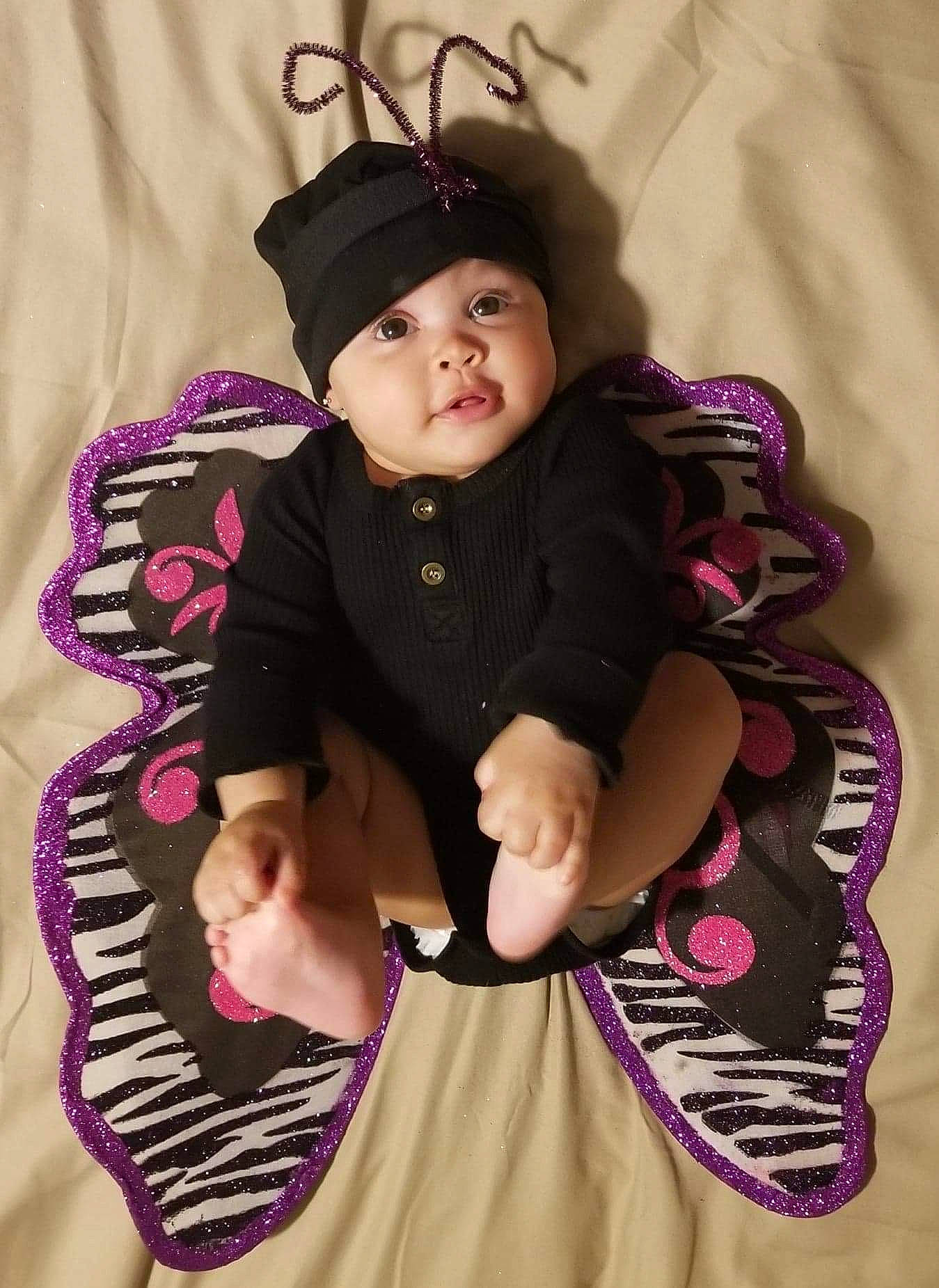 Catori is registered to the contest to win money with this photo: baby, baby_toddler_clothing, clothing, costume_hat, dress, fashion, happy, headgear, headwear, jewellery, magenta, necklace, outerwear, pattern, person, pink, purple, sleeve, textile, toddler