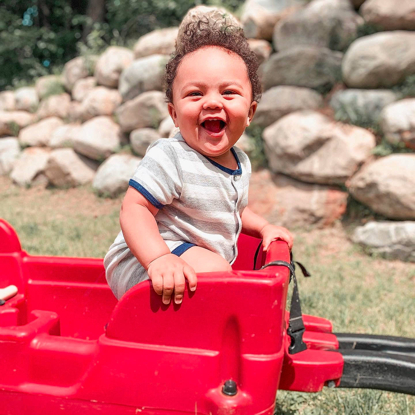 Tayvon is registered to the contest to win money with this photo: child, fun, happy, leisure, outdoor_play_equipment, person, play, playground, public_space, recreation, sitting, smile, summer, toddler, vacation, vehicle
