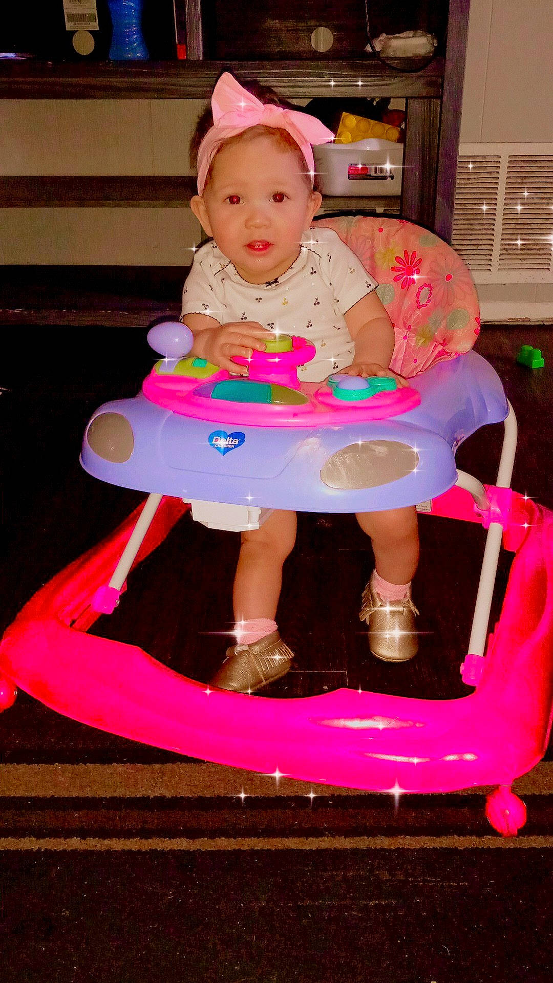 A'Naya is registered to the contest to win money with this photo: baby, baby_products, baby_toddler_clothing, cap, child, event, facial_expression, fun, lap, magenta, party, person, pink, product, purple, red, sandal, sitting, sock, toddler