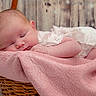 baby, basket, cheek, close_up, cozy, cute, ear, fabric, face, hand, infant, lace, newborn, peaceful, pink_blanket, portrait, sleeping, soft_texture, wicker, wooden_background