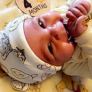 Tatum joined the competition — help win amazing prizes! baby, infant, newborn, hat, blanket, milestone, 4_months, cute, hands, lying_down, soft, warm_light, sleepy, face, skin, clothing, child, portrait, closeup, comfort