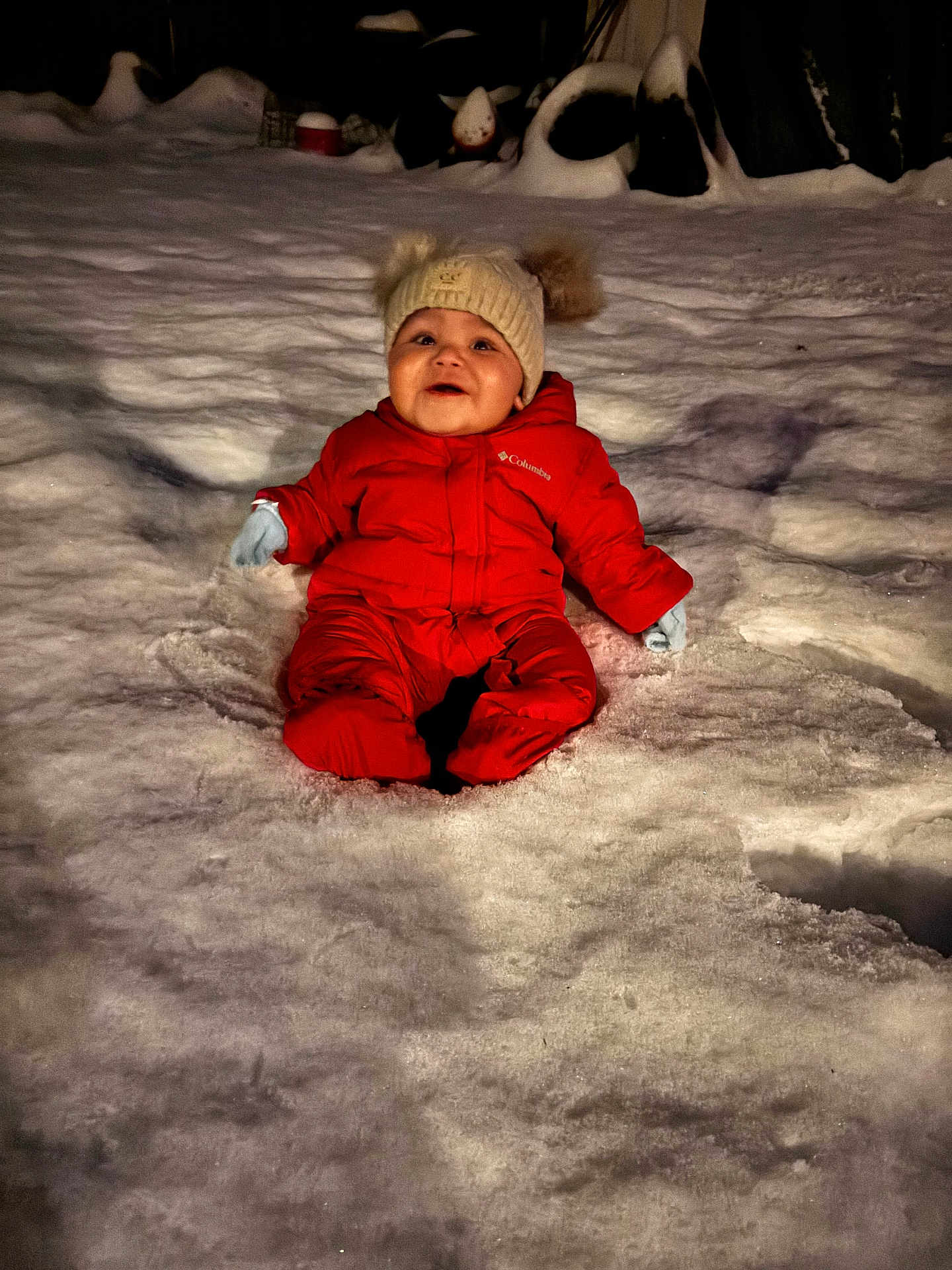 Tatum joined the competition — help win amazing prizes! baby, child, snow, red_snowsuit, winter, hat, gloves, outdoor, night, cold, smiling, happy, snowy_ground, warm_clothing, infant, cute, fun, playful, seasonal, puffy_jacket