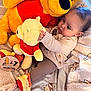 Tatum joined the competition — help win amazing prizes! baby, infant, plush_toy, stuffed_animal, winnie_the_pooh, blanket, milestone_marker, 7_months, cuddly, cute, child, soft_toys, cozy, warm_clothing, indoor, portrait, closeup, playtime, smiling, happy
