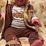 Tatum is registered to the contest to win money with this photo: baby, infant, winnie_the_pooh, clothing, brown_pants, vest, blanket, wooden_sign, 9_months, cute, child, sitting, indoors, portrait, face, feet, hand, expression, soft_texture, cozy