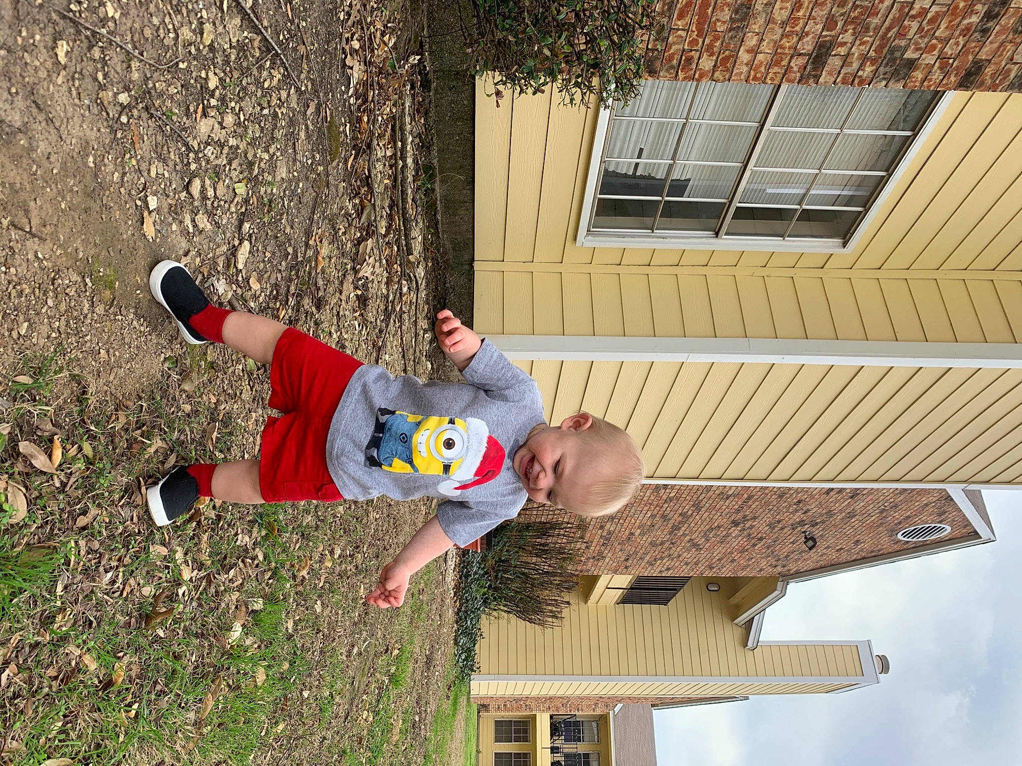 Graeson is registered to the contest to win money with this photo: facade, grass, leisure, person, plant, recreation, shorts, sky, soil, t_shirt, tree, walking_shoe, window, wood