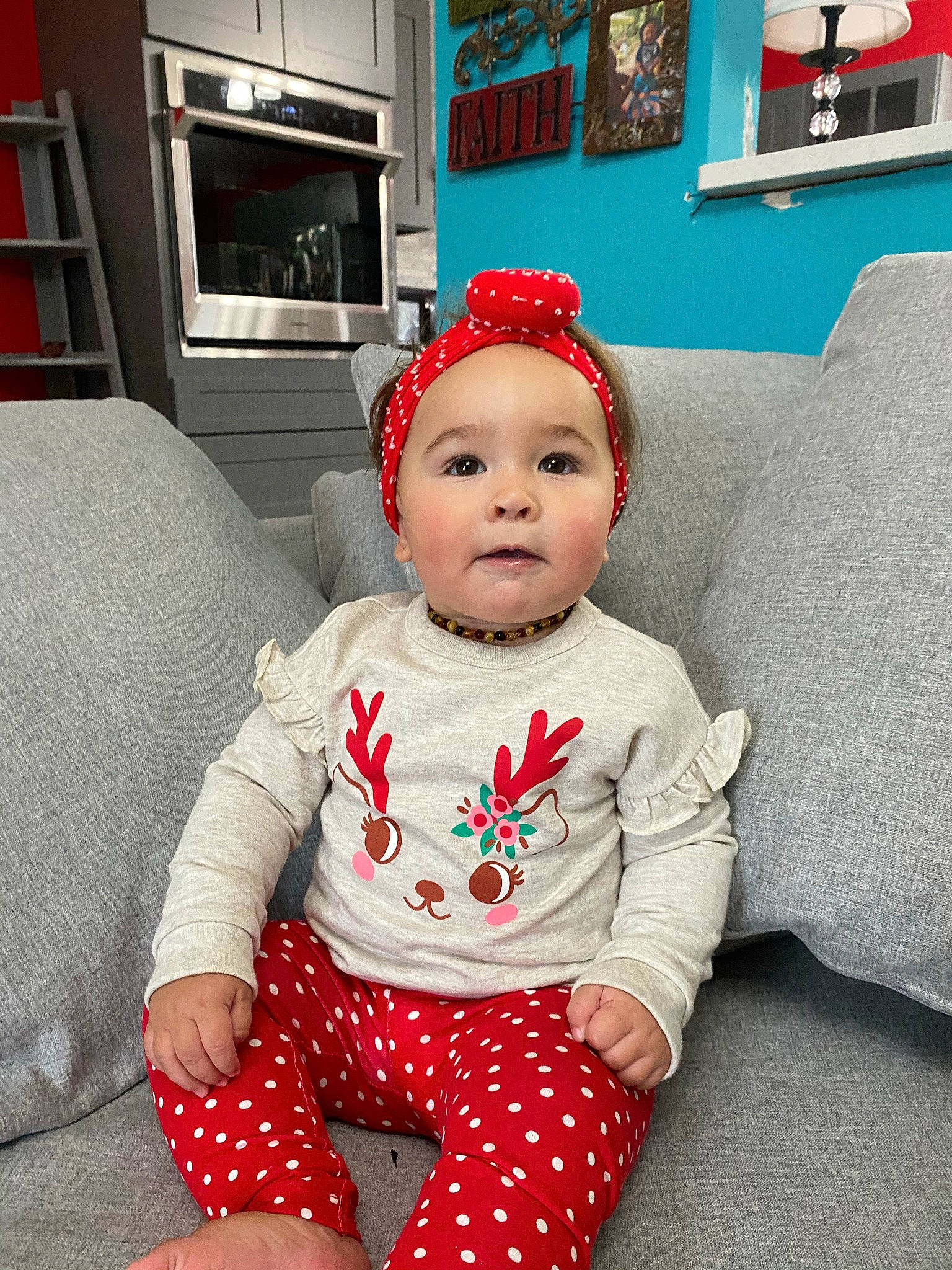 Gracee joined the competition — help win amazing prizes! baby, baby_toddler_clothing, child, comfort, costume_accessory, couch, display_device, headwear, home_accessories, human_body, lap, living_room, nightwear, pajamas, person, picture_frame, shelf, shelving, sitting, sock
