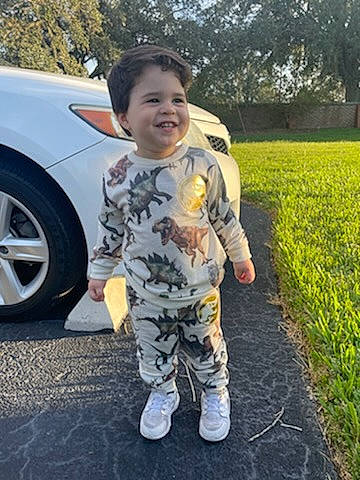 Jeremiah joined the competition — help win amazing prizes! asphalt, automotive_exterior, automotive_tire, bumper, car, cool, family_car, grass, happy, joy, military_camouflage, person, plant, shoe, smile, sneakers, tire, toddler, toy, tree