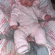 Lainey joined the competition — help win amazing prizes! baby, infant, pink_clothing, hooded_outfit, baby_seat, patterned_cushion, indoor, portrait, child, cute, baby_girl, face, seated, clothing, looking, expression, small_hands, soft_texture, cozy, adorable