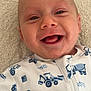 Jackson joined the competition — help win amazing prizes! baby, smiling, face, infant, onesie, blue, construction_vehicle_pattern, lying_down, closeup, happy, child, cute, apparel, fabric, skin, head, eyes, mouth, indoor, portrait